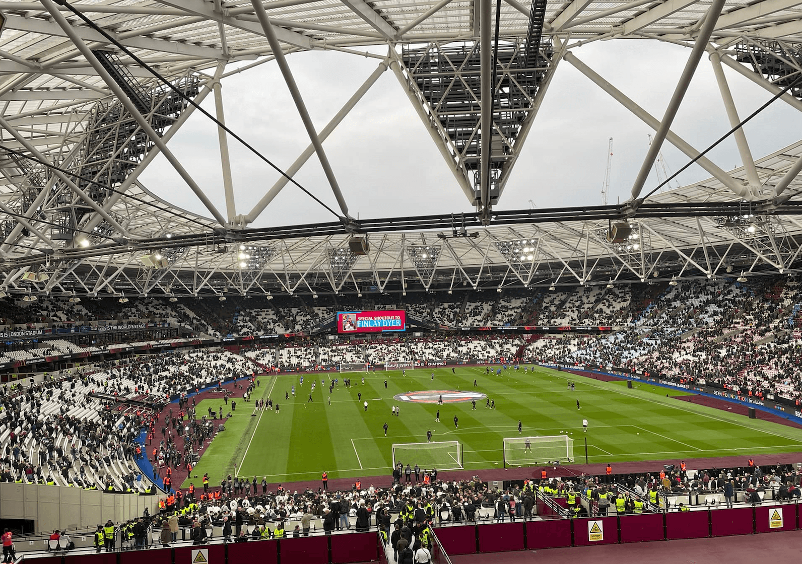 London Stadium filling fans before a West Ham United home match, viewed from the shortside upper tier