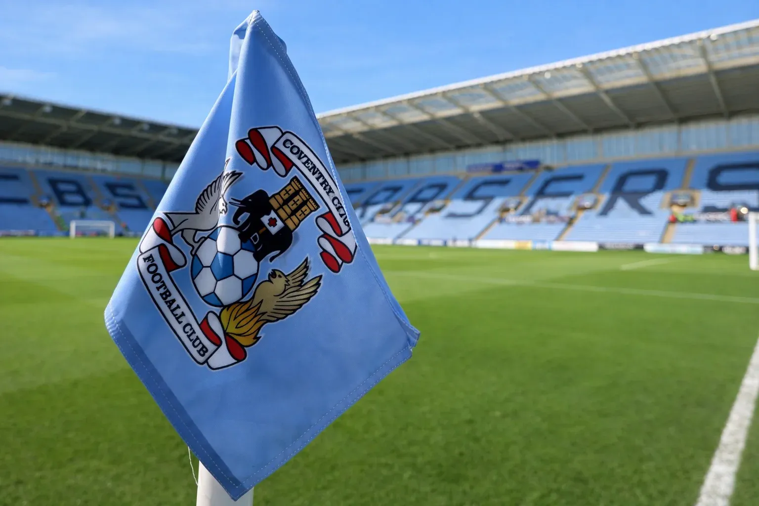 Coventry City corner flag at Coventry Building Society Arena with pitch and stands in background