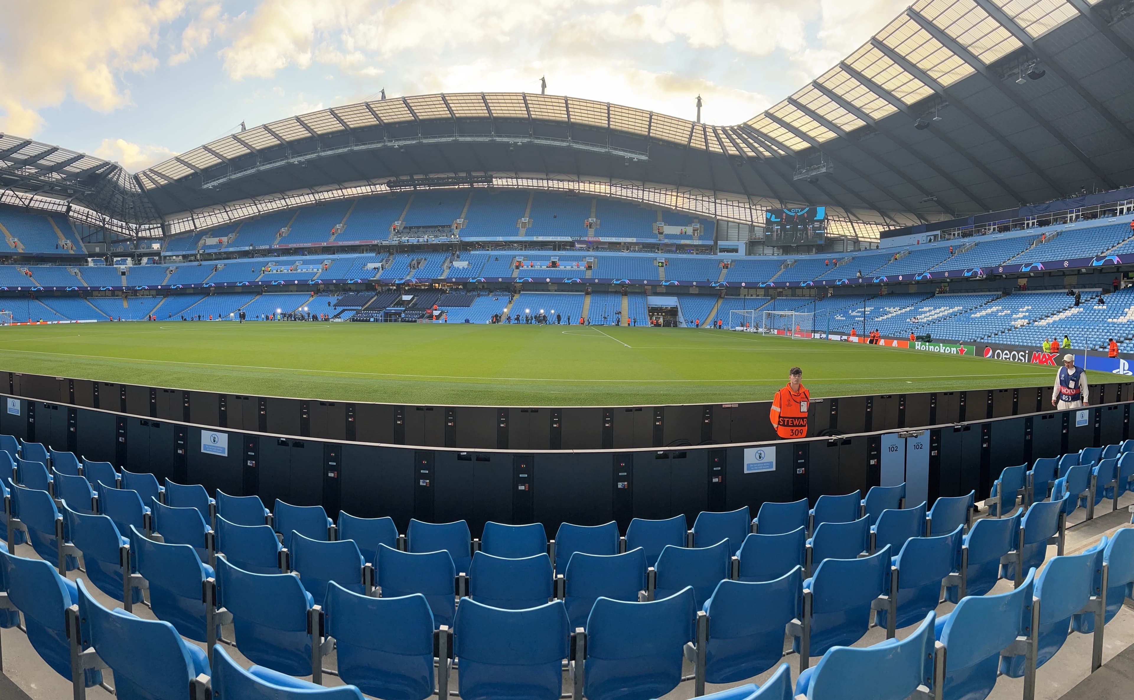 Etihad Stadium inside panoramic view Manchester City pitch blue seats roof structure