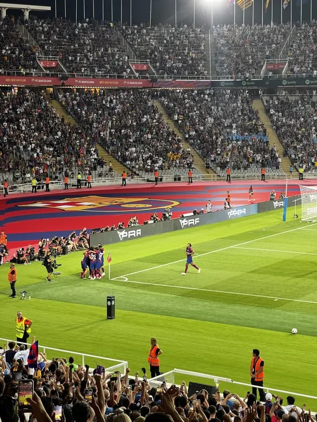 FC Barcelona players celebrating a goal at Estadi OlĂmpic LluĂs Companys in MontjuĂŻc