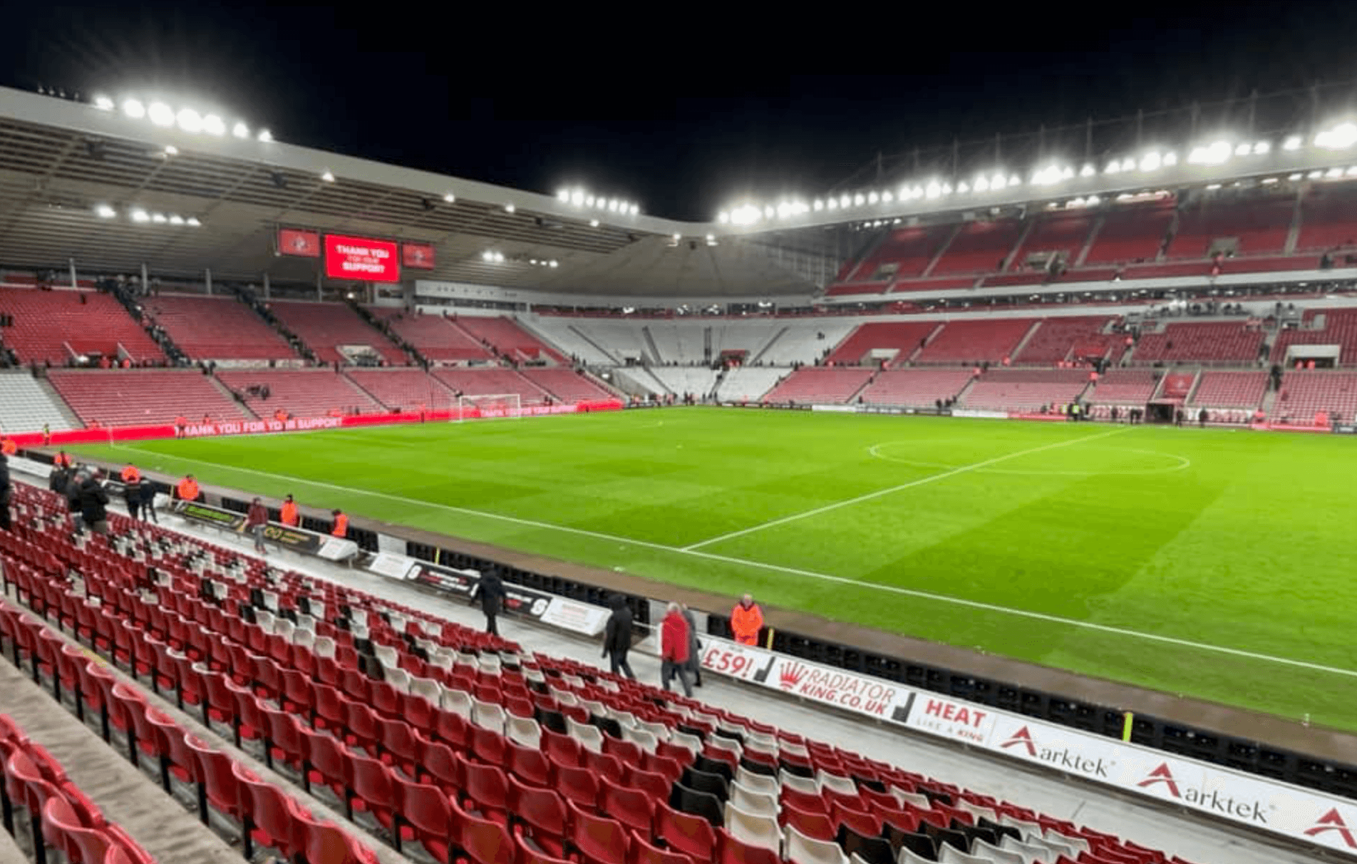 Empty Stadium of Light pitch-side view after the final whistle with floodlights on