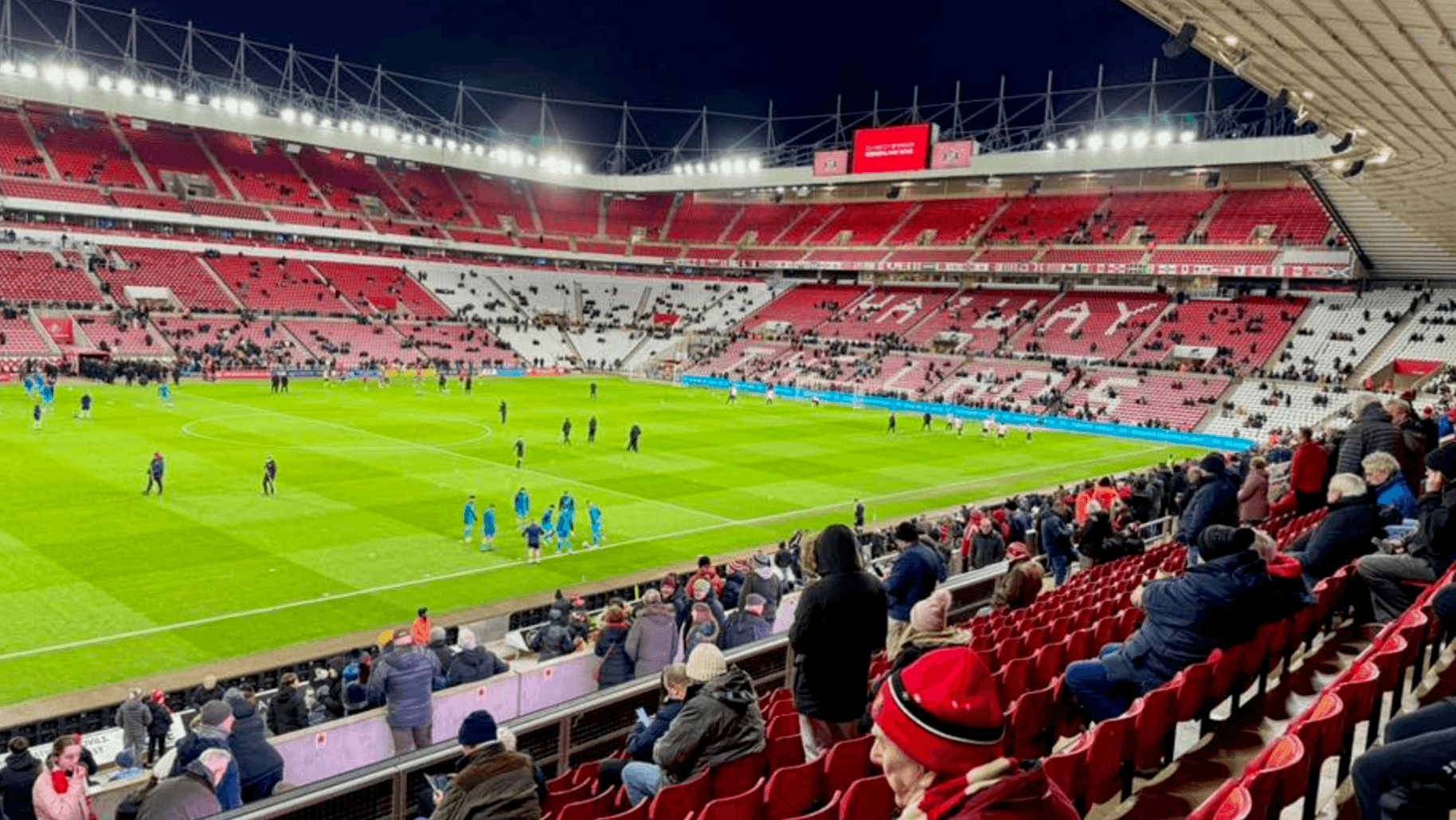 Inside the Stadium of Light during pre-match warm-up, viewed from the lower tier