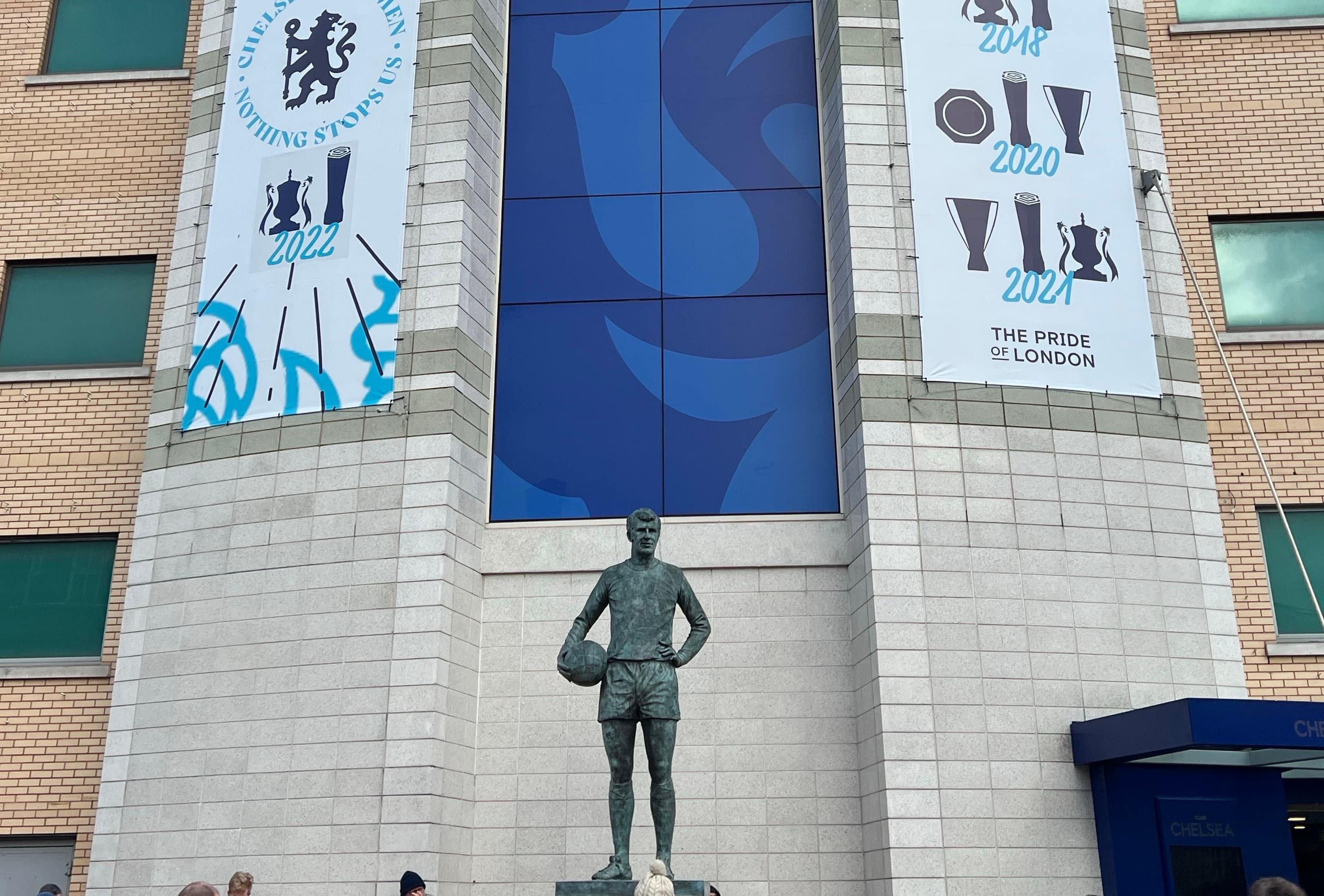 Stamford Bridge Chelsea FC entrance Peter Osgood statue trophy banners Pride of London Premier League Champions League